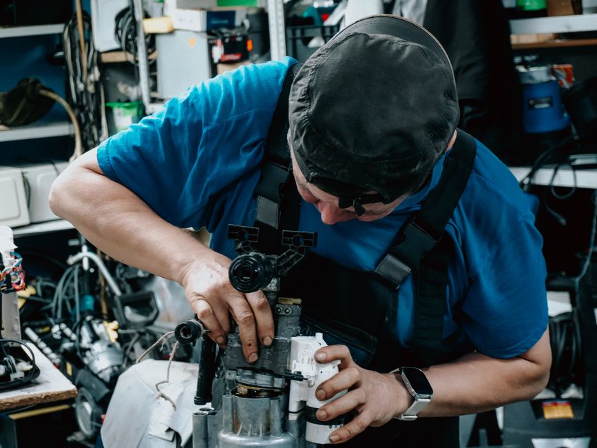 Technik opravuje pračku přímo u zákazníka doma